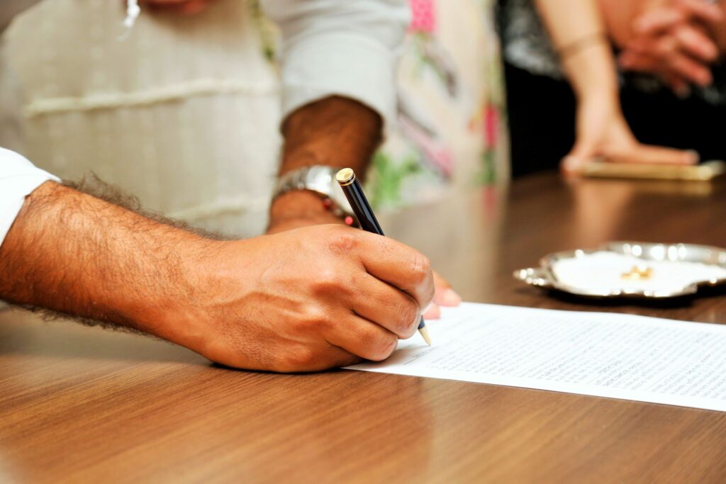 Mobile notary witnessing the signing of legal documents at a client appointment