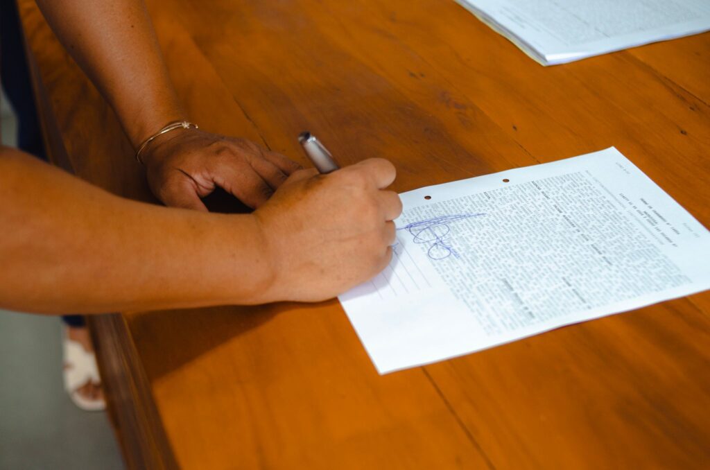 Hands signing a legal document during a mobile notary appointment in the Phoenix metropolitan area
