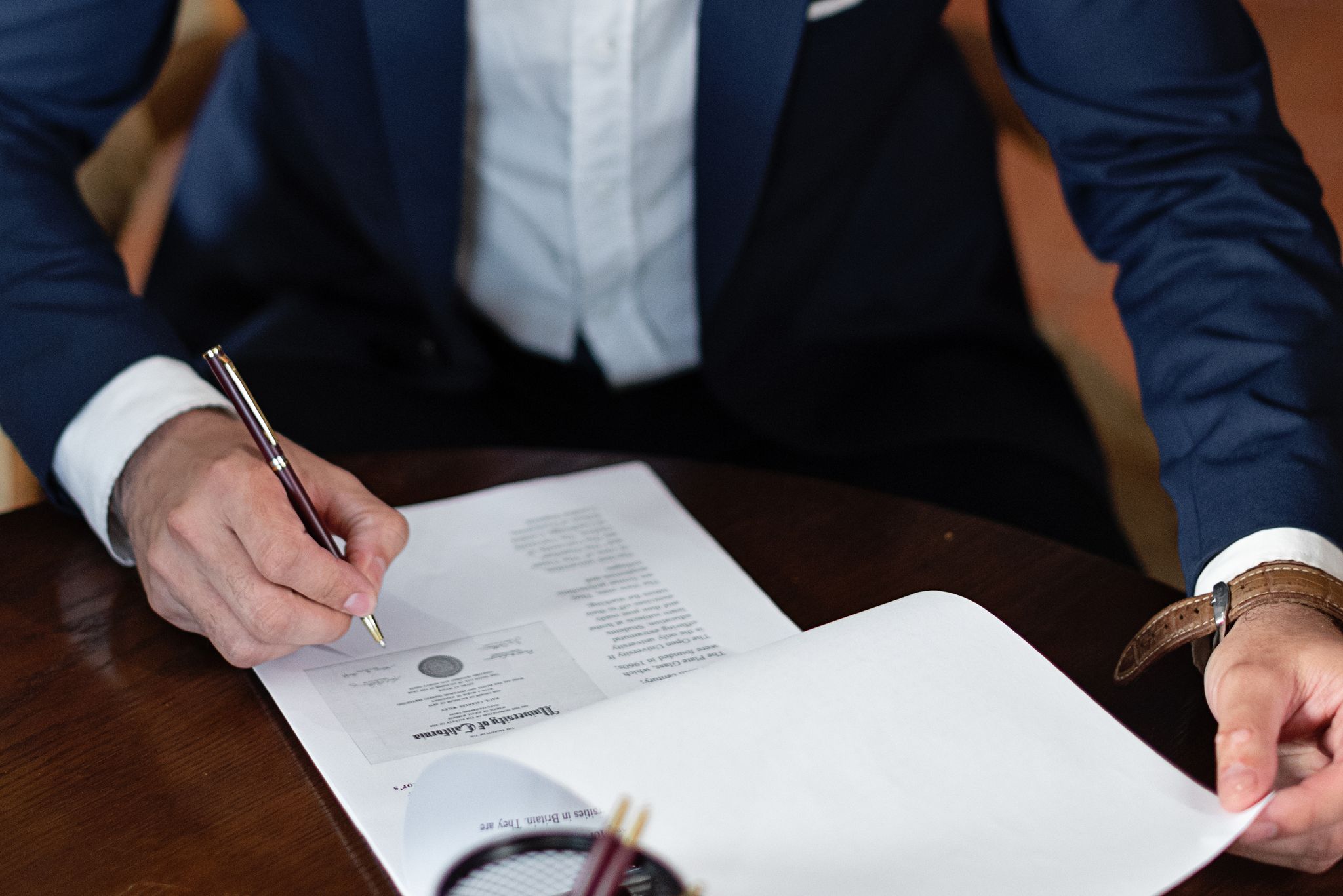 Professional signing legal documents at a desk during an office appointment in Arizona